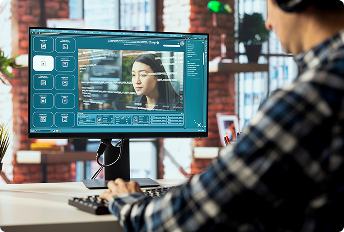 Automating Logo Replacement Across Local Feeds with Vantage AI-Vision. Man sitting at monitor green background screen making edits