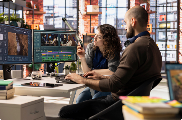 2 people at office Diva video editing and monitoring on computers