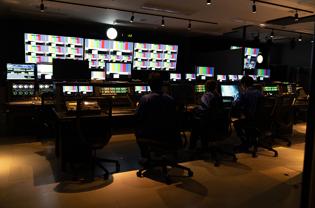 dark broadcast studio with monitors showing color testing
