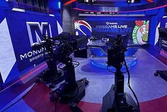 Sports broadcast studio with professional cameras aimed at a central desk, featuring large screens displaying “Monumental Sports Network” and “FanDuel Pregame Live” with team logos in the background.