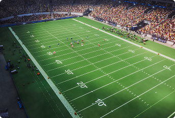 American football field during a live game with players positioned near the center, surrounded by a packed stadium with fans in the stands and team benches along the sidelines