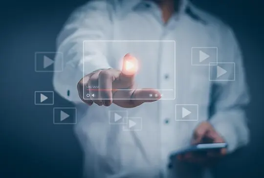 man touching transparent touch screen in front of him